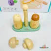 My Little Cooking Playset wooden salt and pepper shakers marked S and P on a mint green holder, with two mushroom-shaped wooden toy accessories displayed in front of the packaging.